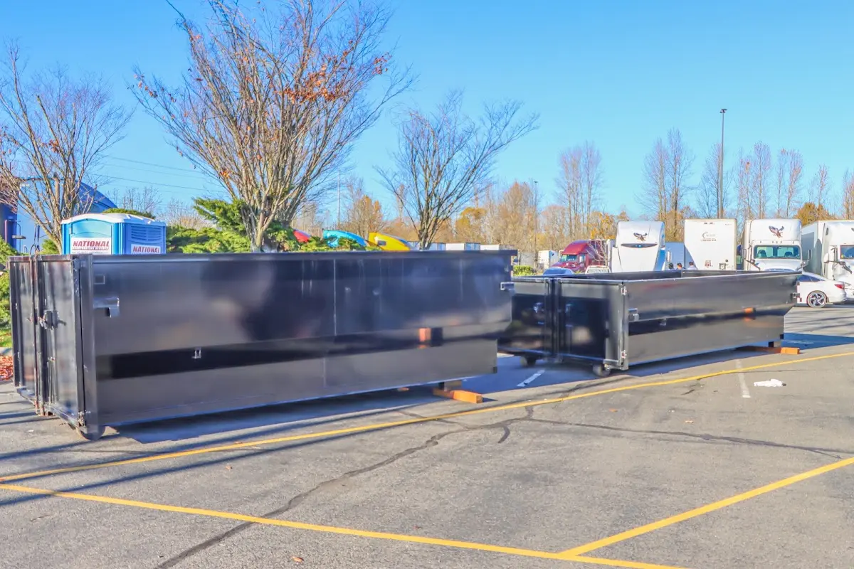 Professional dumpster rental service with roll-off container on residential driveway in Oshkosh